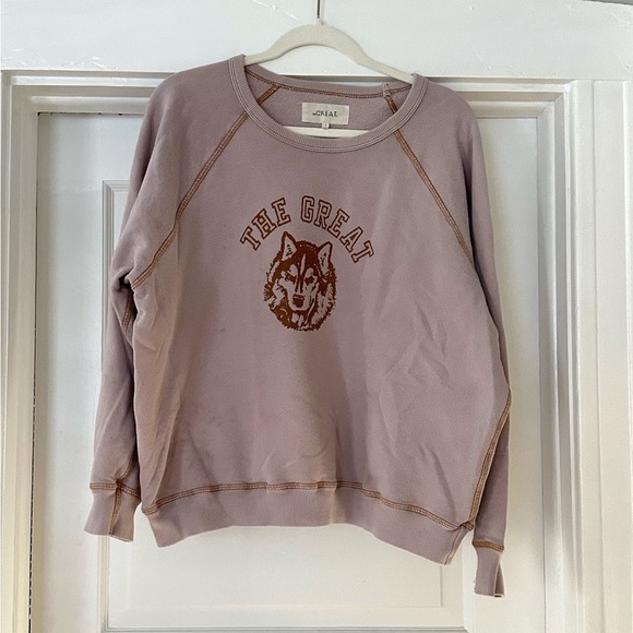 THE GREAT. Tops - The GREAT College Sweatshirt. Lavender with contrast stitching. Wolf graphic.